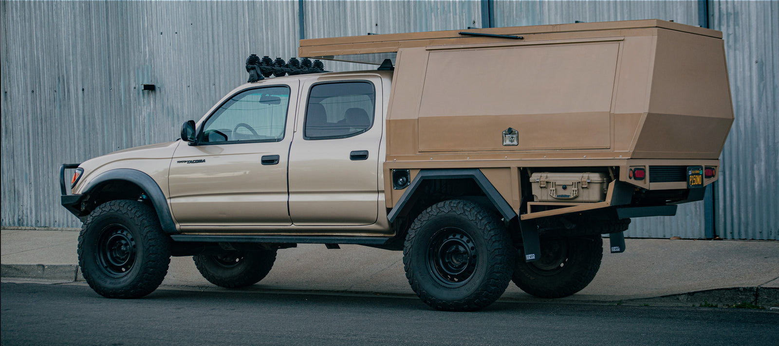 Custom Toyota Tacoma Camper Conversion Build. Car Camping with HEST blog post. Light brown tacoma toyota truck with custom camper back.