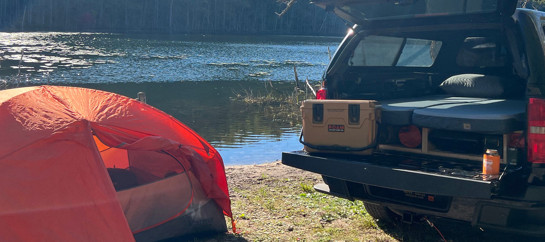 Chevy colorado truck bed infront of a lake with the tailgate down