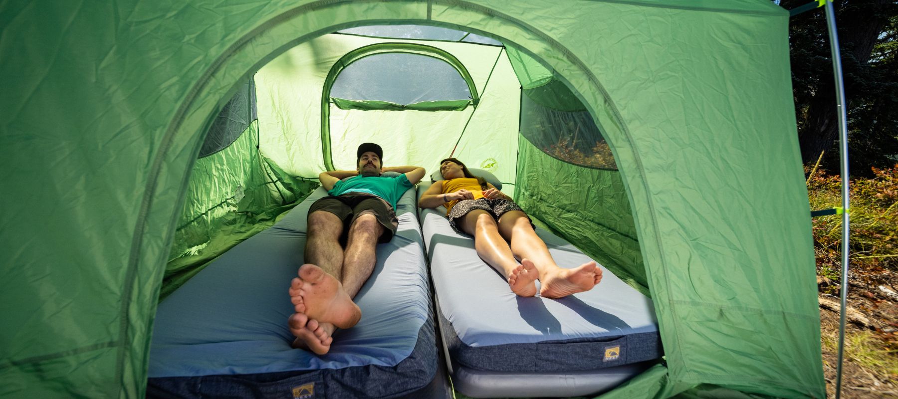 2 people laying on the HEST Sleep System in a tent