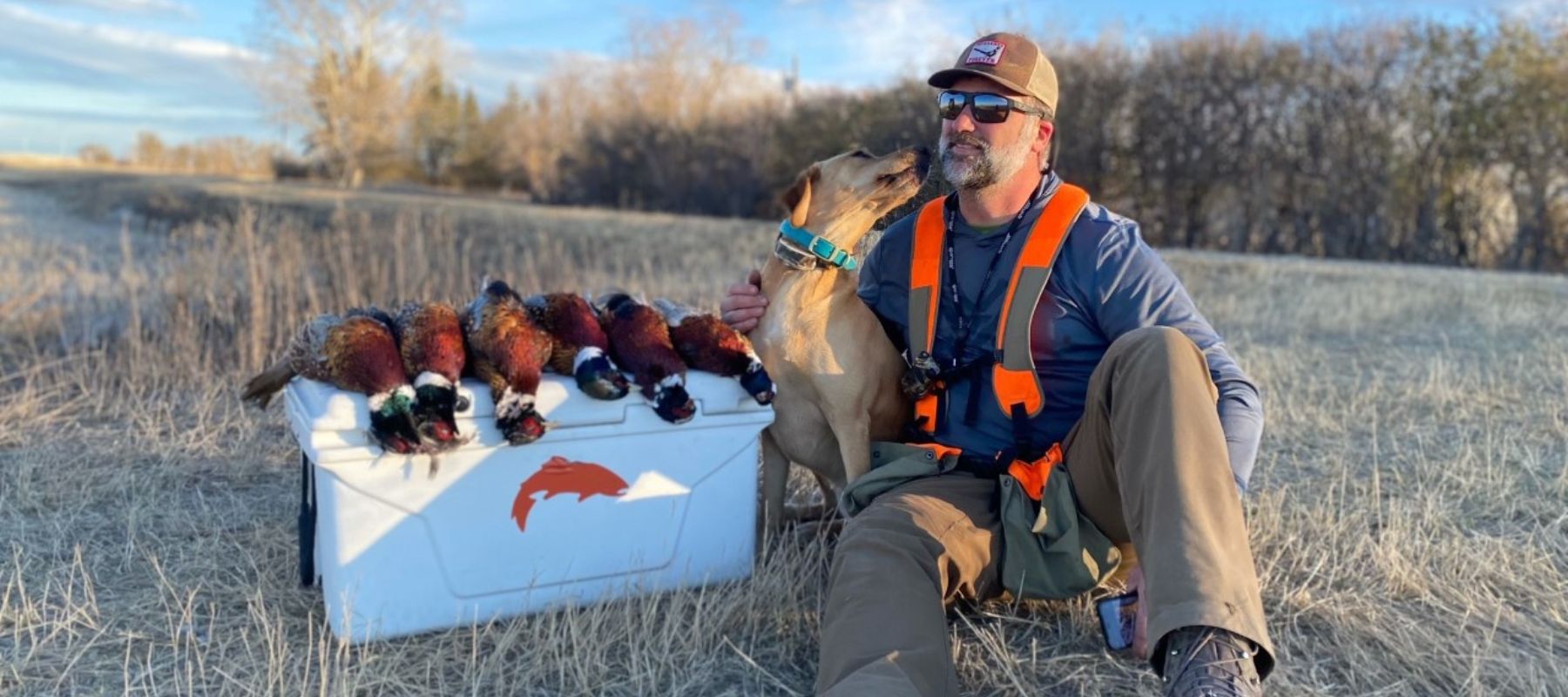 man with his dog after hunting pheasants