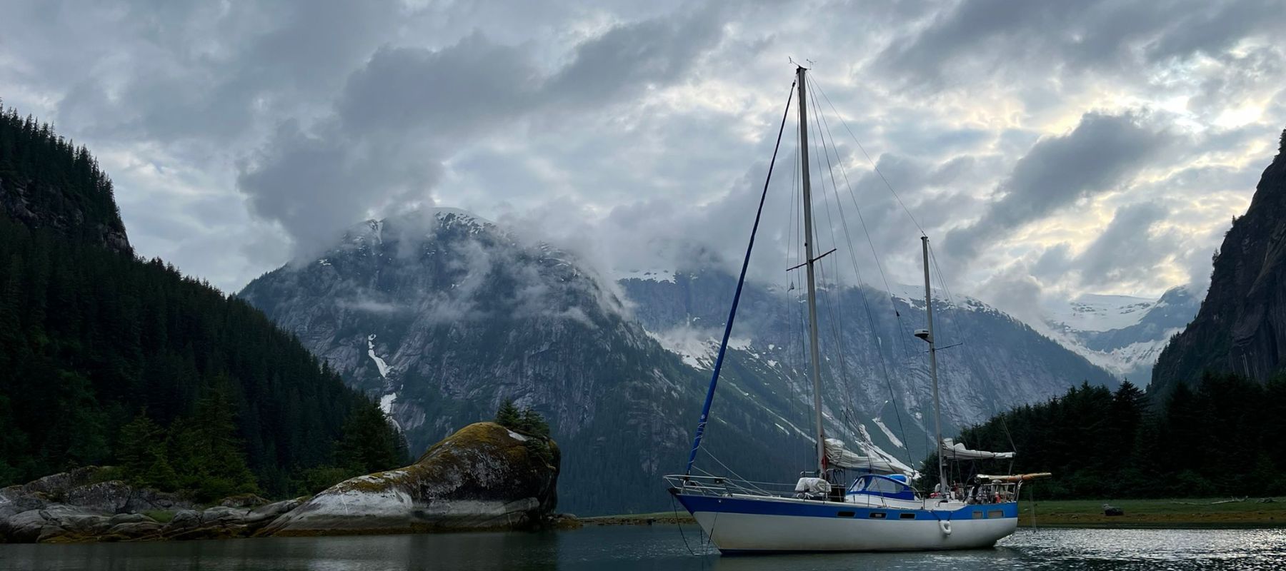 sail boat sailing through alaskan waters