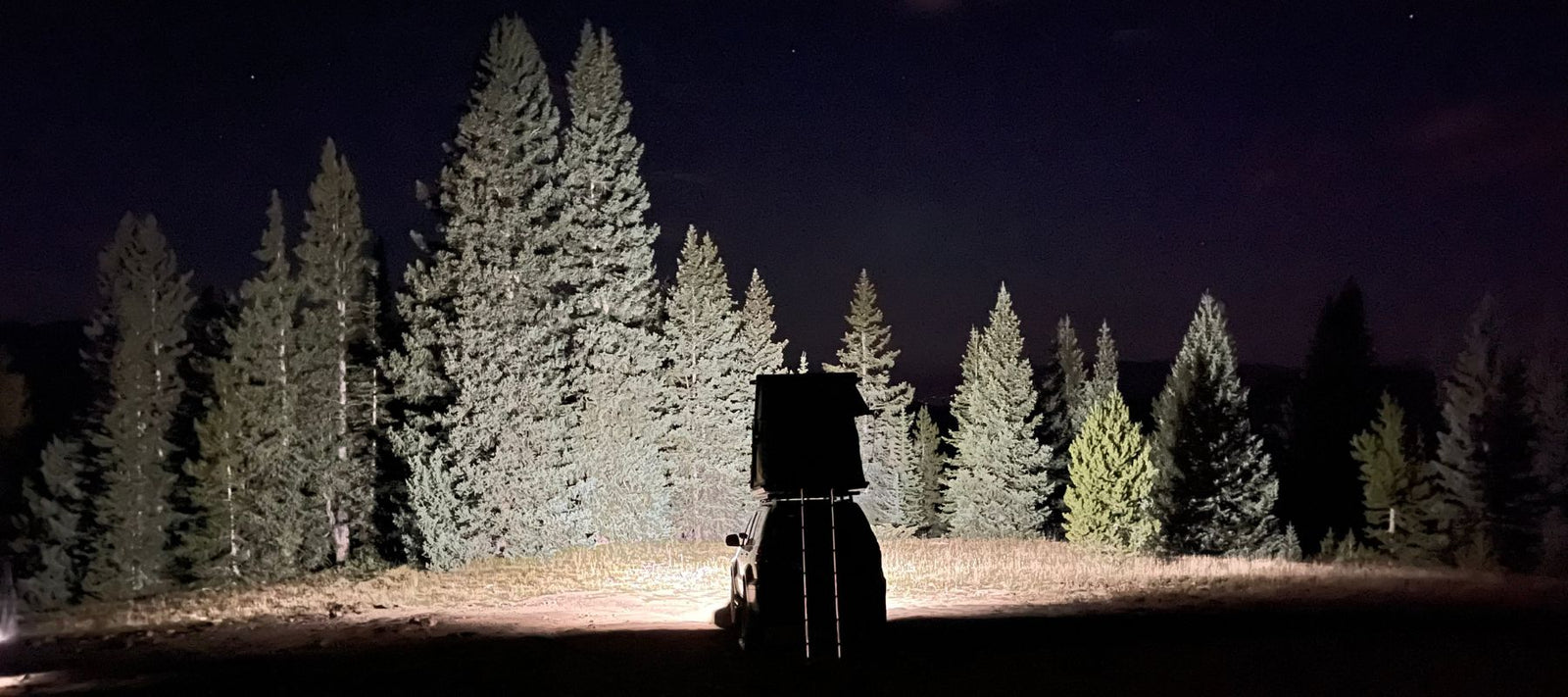 2007 lexus gx450 parked in camping spot with starry skies in background